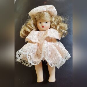 Teeny Tiny little Porcelain Doll with golden curls. Super cute.